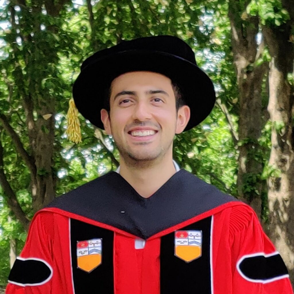 Carlos Rivera in graduation robes