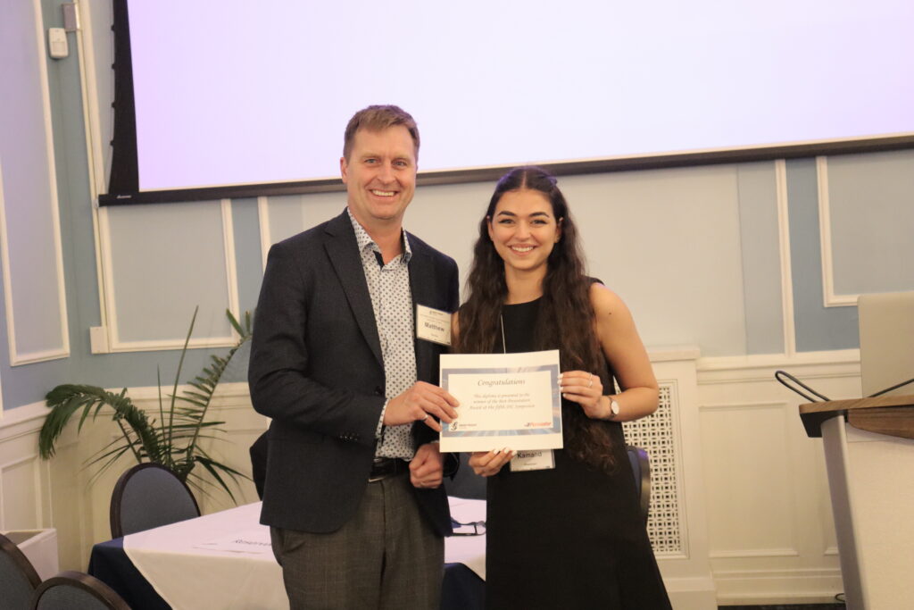 Kamand Khosravian being awarded with a certificate for the 2023 Smart Freight Symposium's Best Presentation Award. 