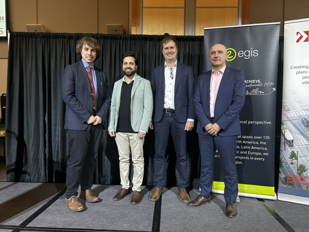 The image from left to right shows Eric Nevland (the president of the ITE Toronto Chapter), Dr. Usman Ahmed (the post-doctoral fellow who is the U of T project manager of the Purolator project), Dr. Matt Roorda (Professor of Civil Engineering at UofT), and Mehemed Delibasic (McIntosh Perry’s assistant vice president.)